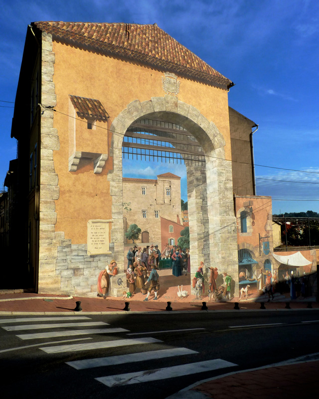 Entering Carcès, one of many clever murals awaits visitors. This one portrays the town as it would have looked in another era. Photo by Stacy Silverwood.