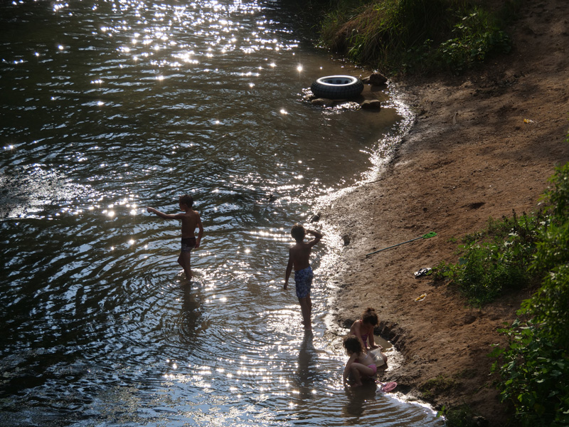 Kids enjoy swimming in the river.